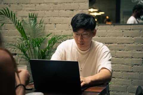 Adult studying with laptop